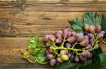 Bunch of grapes on wooden backgroundの写真素材