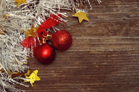 Christmass balls and tinsel on wooden backgroundの写真素材