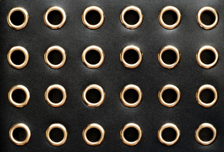 Black leather with holes for backgroundの写真素材