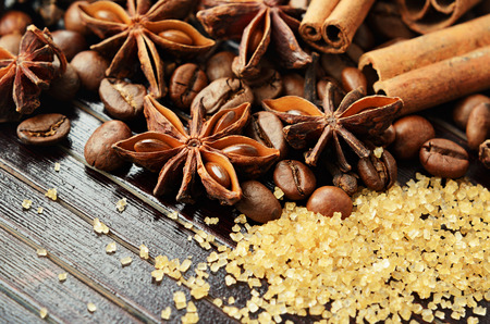 Fragrant spices coffee and reed sugar on a wooden backgroundの写真素材