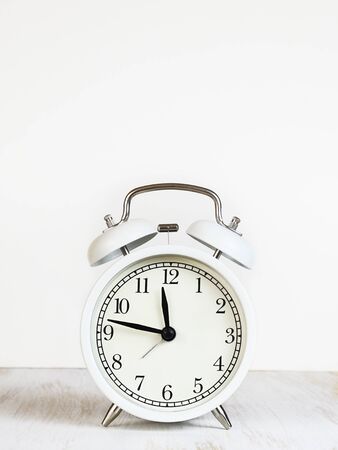 White alarm clock on white backgroundの写真素材