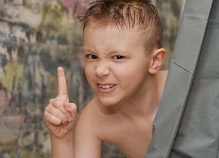 the boy looks out in the bathroom, bathes, in shock, surprised