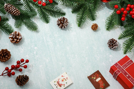 Christmas background with fir branches, cones and red berries. Top view with copy spaceの写真素材