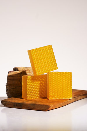 Honeycombs on a cutting board on a white background.の写真素材