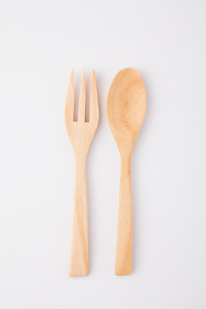 wooden spoon and fork isolated on white backgroundの写真素材