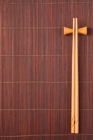 Two chopsticks on a bamboo matの写真素材