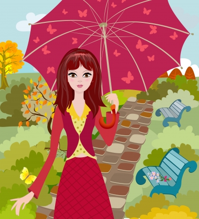 Girl with umbrella in autumn parkの写真素材