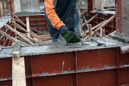 hand using smooth the cement screed with trowelの写真素材