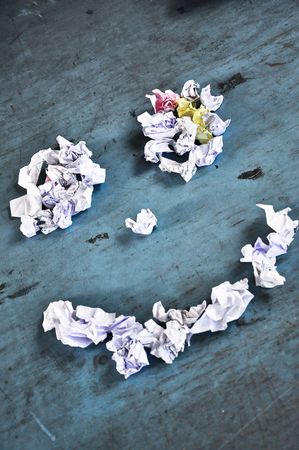 smile made of paper bills on a blue wooden tableの写真素材