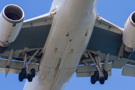 A close up of the main landing gear on a modern passenger jet aircraft as it comes in to land.の写真素材