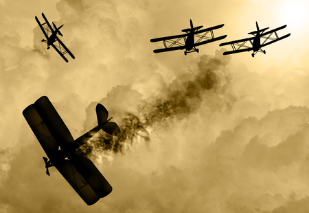 Vintage world war one biplanes and triplanes engaged in a dog fight  in a cloudy sky. One had success in shooting down the enemy plane. Original Illustration image.の写真素材