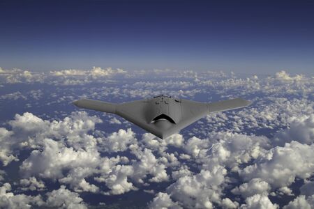 A modern military drone flying high above the cloudsの写真素材