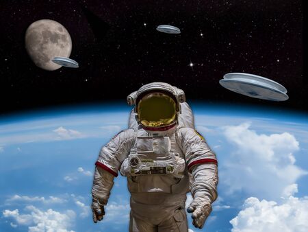 3 UFOs entering the earths atmosphere with the moon visible in the distance. An Astronaut in foreground. Welcome our new overlords! - Artist Impressionの写真素材