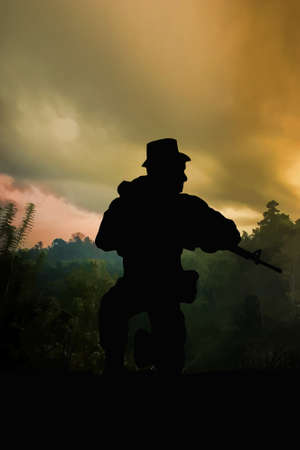 Silhouette of American special forces soldier on patrol in therice paddies and jungle of Vietnam. (Artist illustration)の写真素材