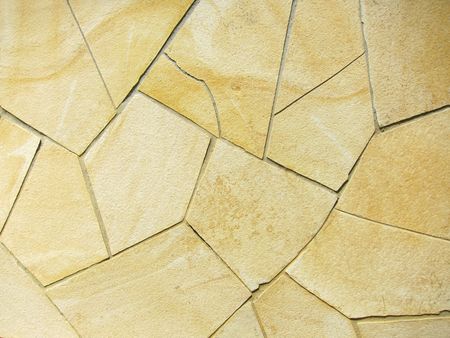Stone wall textured background in yellow color 