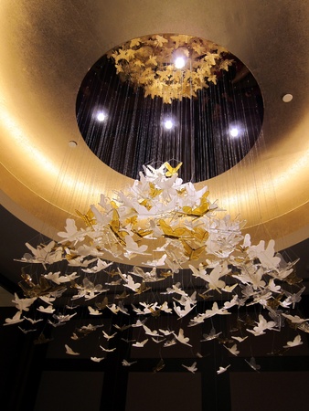 Large ornate modern lighting hanging above restaurant roomのeditorial素材