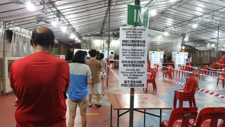 Singapore - 27 May, People are queuing up with a safe distance apart to collect the free reusable...