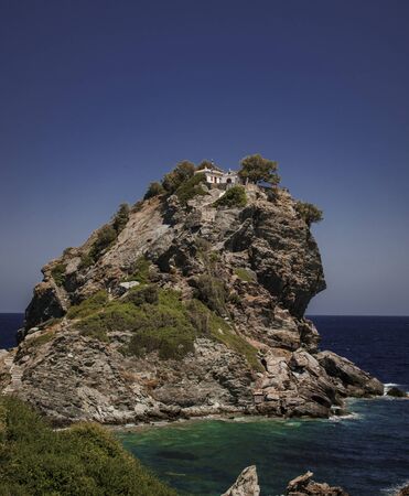 A small chapel on top of the rock in Greek island.の写真素材