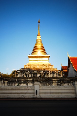 Golden temple stupa in Thailand against clear blue skyの写真素材