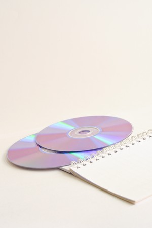 CD and Notebook on white backgroundの写真素材
