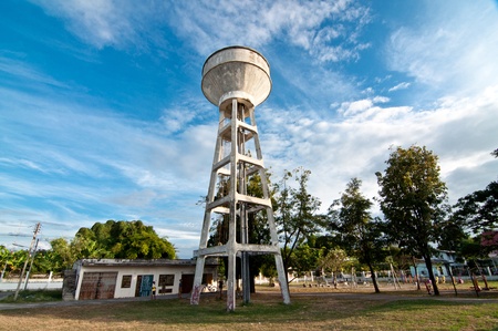 Water tower painted in white against blue sky の写真素材