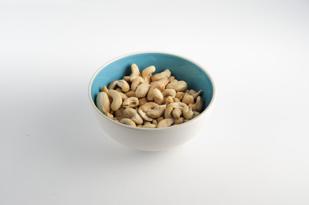 Cashew nuts on bowl on a white backgroundの写真素材