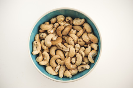 Cashew nuts on bowl on a white backgroundの写真素材