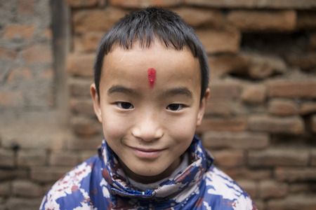 BHAKTAPUR, NEPAL, November 15: Portrait of young Nepalese boy and girl with red dot on his face posing at the camera, Nepal 2015.のeditorial素材