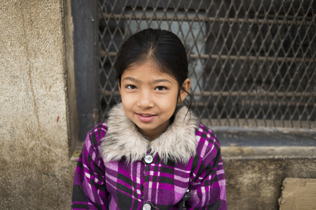 BHAKTAPUR, NEPAL, November 15: Portrait of young Nepalese girl on his face posing at the camera, Nepal 2015.のeditorial素材