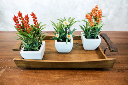 Flower in the white vase on a wood tableの写真素材