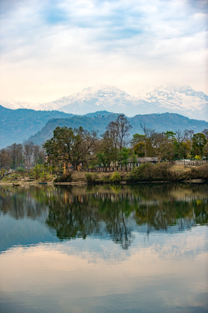 Lake Phewa in Pokhara, Nepal, with the Himalayan mountains in the background, including Machhapuchhre and Annapurnaの写真素材