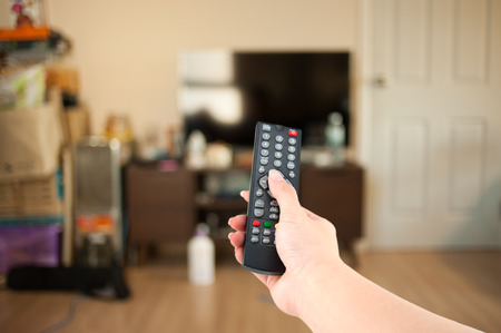 Program switching or button pressing on TV remote controlの写真素材