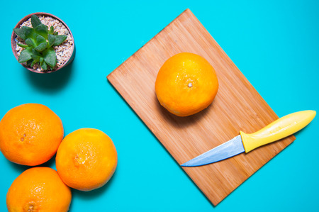 Fresh orange fruits and juice on marble table.