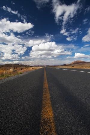 Image of a road in the karoo desert of South Africa with Cloudsの写真素材