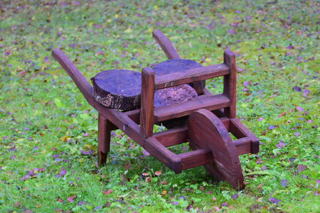 Garden ornaments: a wooden wheelbarrow.の写真素材