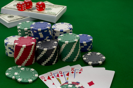 Chips for poker on the green background, shallow depth of field 