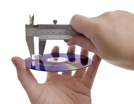 Measuring the size of information within the digital media using a caliper. Concept of information storage and compression.の写真素材