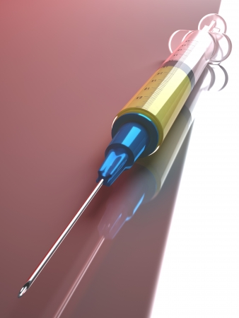 Syringe with medicine on reflective surface. の写真素材