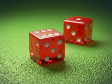 Red dice on green table gambling. Clipping path included.の写真素材