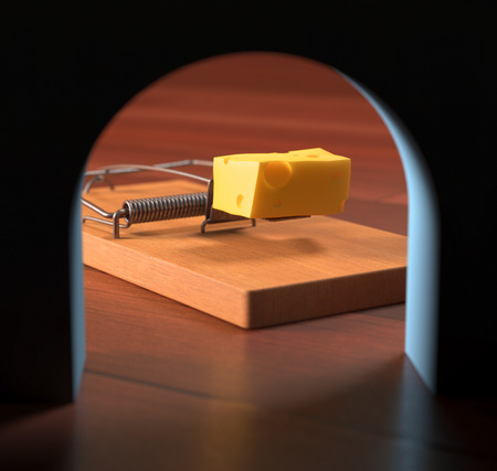 Looking from the hole, the mousetrap with cheese across the wall.の写真素材