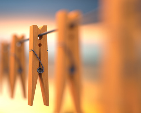 Wooden clip on steel wire in depth of field.