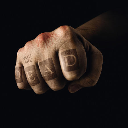 Closed fist with death tattoo on the fingers. Concept of violent sports.の写真素材