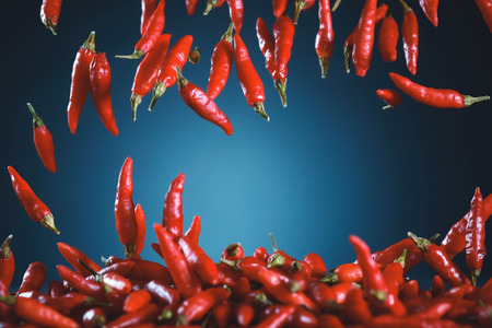 Red peppers falling. Image with depth of field and motion blur.