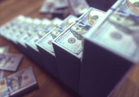 Dollar bills stacked in shape of growing bar chart. Concept of success in business.
