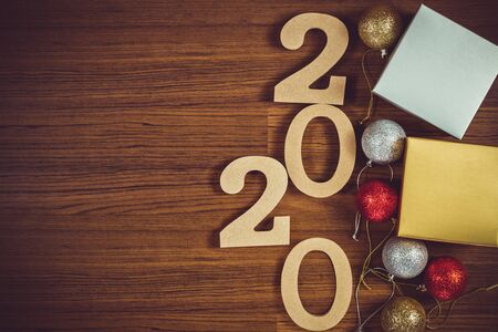 Happy new year. Wooden numbers 2020 on wooden background.
