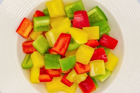 Sliced bell pepper in single white ceramic bowl.