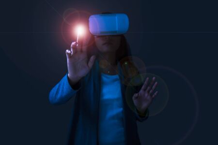 Young woman using VR or virtual reality headset.