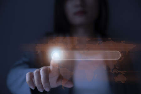 Woman is pressing button to search for information on the United States from virtual map. Future technology concept.の写真素材