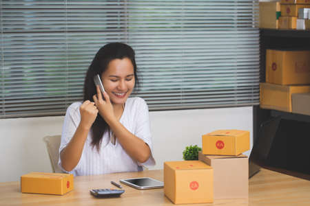 Asian female sellers are happy after receiving orders from customers and are the start of a new business in a successful freelance trade via online shopping.の写真素材