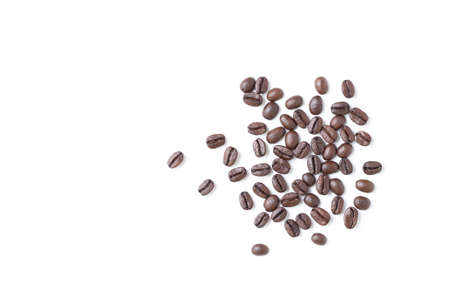 Top view of roasted coffee beans on white background with copy space for text.
